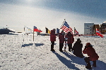 Foto session of the American tourists at ceremonial South Pole