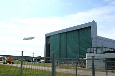 Zeppelin NT taking off next to hangar