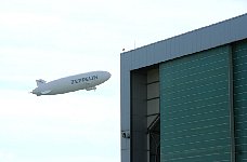Zeppelin NT taking off next to hangar
