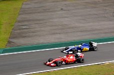 Ferrari and Sauber cars during training session