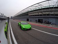 Lamborghini Huracan going wrong way in pitlane and its mirror image on poster