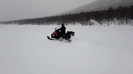 Snowmobile on snowy lake