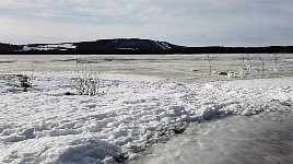 Water on top of frozen lake near Jokkmokk