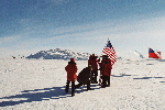 Foto session of the American tourists at ceremonial South Pole