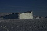 Iceberg in frozen sea