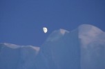 Moon over iceberg