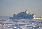 Iceberg in frozen sea