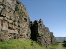 Cliffs at Þingvellir, with flag at Alþing site in background