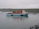 Sightseeing vehicle emerging from Jökulsarlon