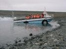 Sightseeing vehicle emerging from Jökulsarlon