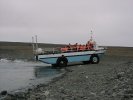 Sightseeing vehicle emerging from Jökulsarlon