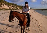 Me, riding along the beach