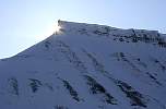 Sun behind hill near Longyearbyen