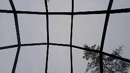 Grey skies from glass igloo