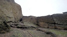 Guide going up smaller crack in the rocks