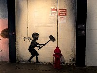 Boy smashing hydrant at Banksy museum in Madrid