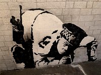 Policeman stencil art at Banksy museum in Madrid