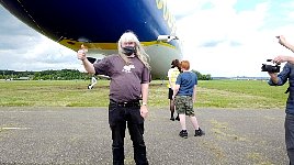 Happy jubilar in front of Zeppelin