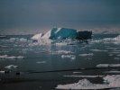 Icebergs and boat at coast at Ilulissat, Greenland