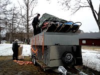Packing food and wood wool on trailer