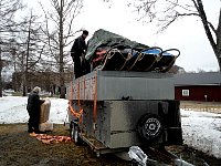Packing food and wood wool on trailer