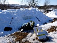 Digging snow hole for dog food