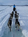 Water filled snowmobile trail on lake