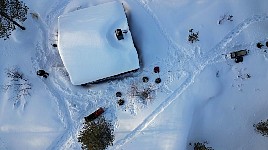 Dog team next to cabin