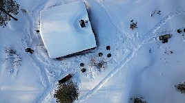 Dog team next to cabin